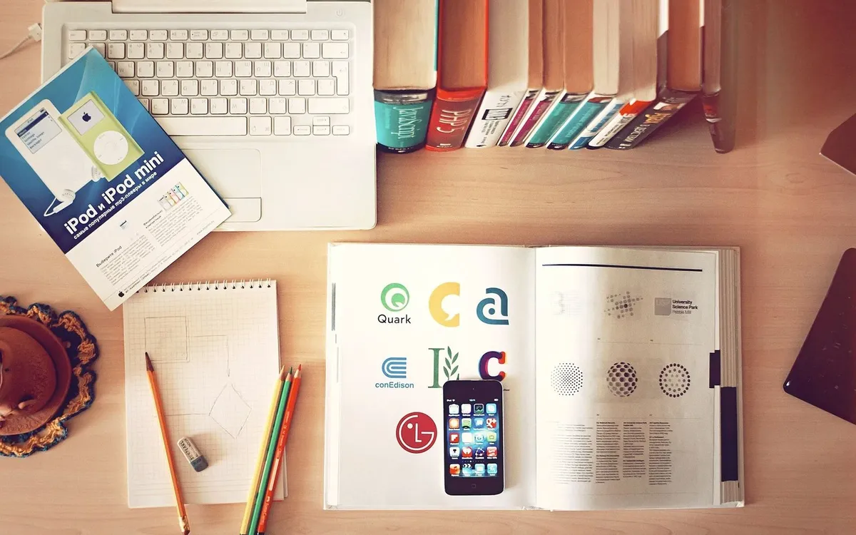Desk with laptop, books and papers