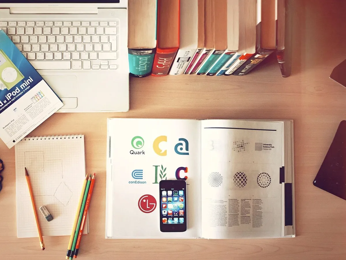 Desk with laptop, books and papers