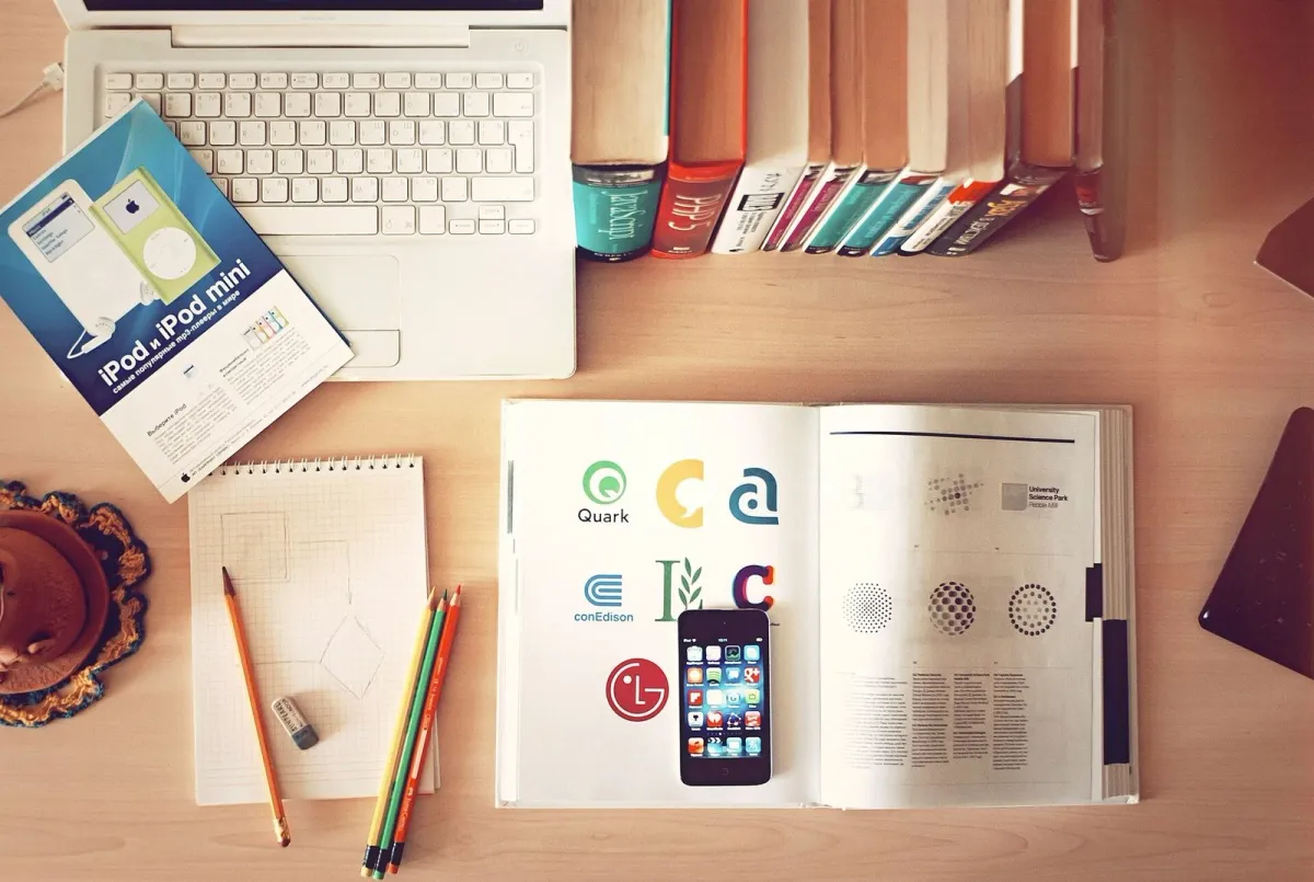Desk with laptop, books and papers