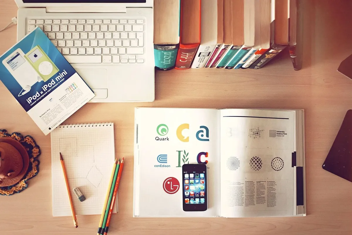 Desk with laptop, books and papers