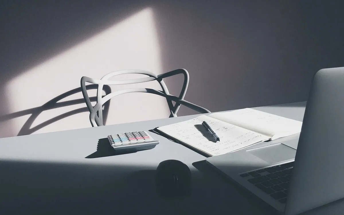 Laptop and calculator on a desk