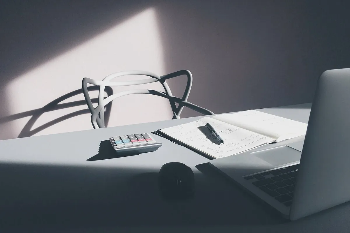 Laptop and calculator on a desk